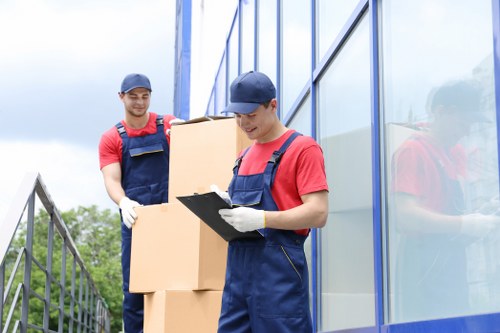 Careful loading of a grand piano into a removal vehicle