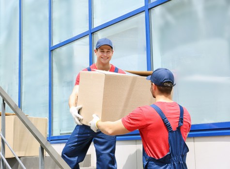 Boxes and furniture being unloaded at a new home in Harrow