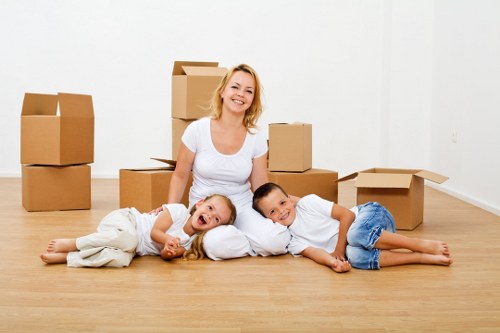 Professional movers transporting furniture during a same day removal
