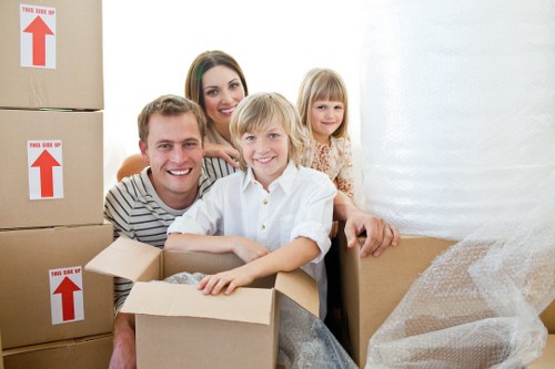 Removalists carrying household items through a Harrow property entrance